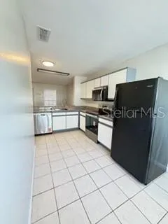 a view of a kitchen with kitchen island wooden floor and window