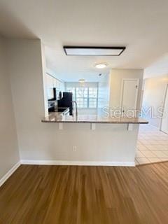 11019 Yorkshire Ridge Court Orlando, FL 32837 - Photo 5 of 15 a view of a kitchen with kitchen island wooden floor and window