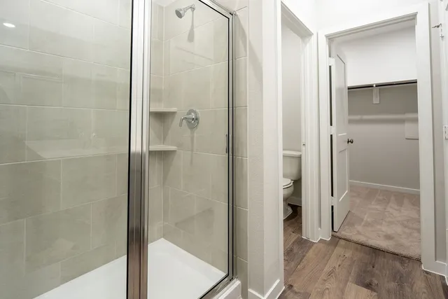 a bathroom with a glass shower door