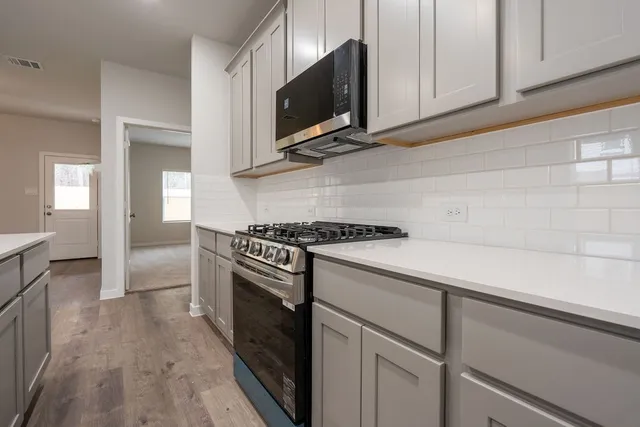 a kitchen with a stove and a microwave
