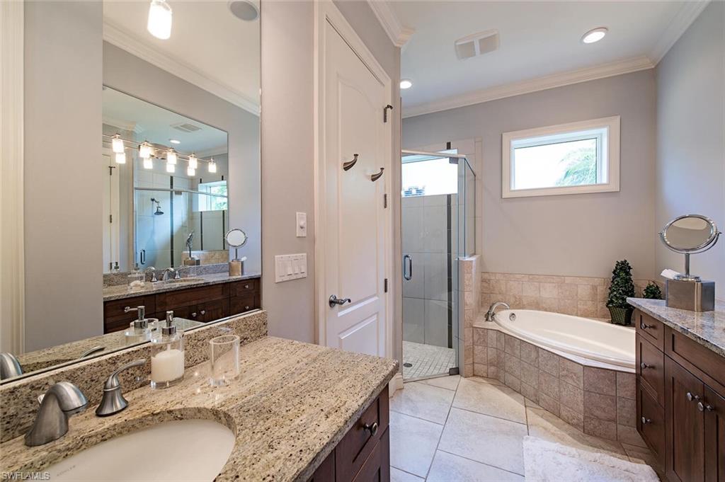 14810 Bellezza Lane Naples, FL 34110 - Photo 11 of 32 a bathroom with a granite countertop tub sink double vanity granite tub shower and mirror