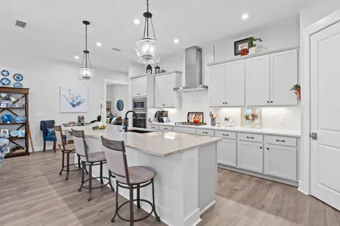 a kitchen with cabinets and chairs