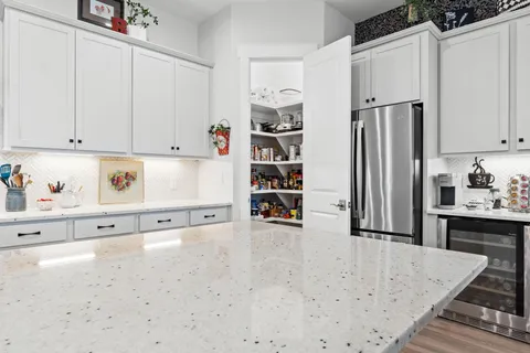 a view of kitchen cabinets and refrigerator