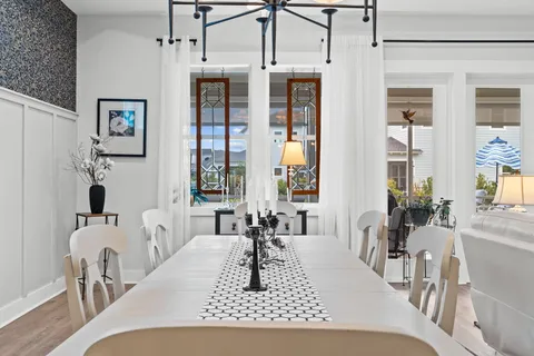 a living room with furniture a large window and potted plants