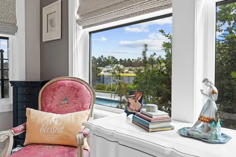 a living room with furniture and a floor to ceiling window