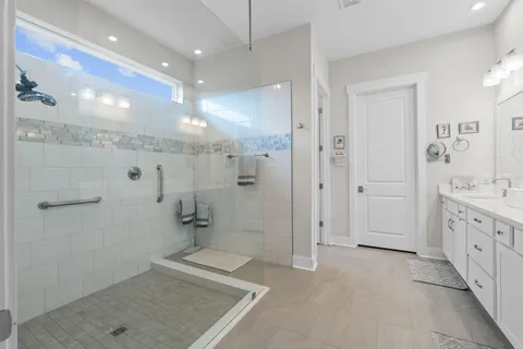 a bathroom with a granite countertop sink a mirror and a shower
