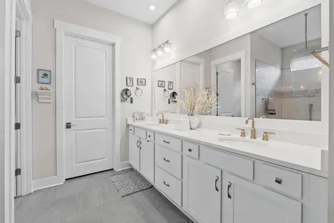 a spacious bathroom with double sink and a mirror