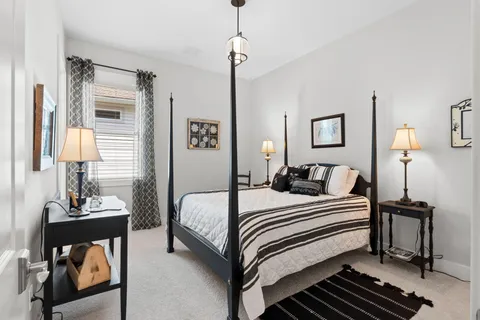 a bedroom with a bed and a lamp on table