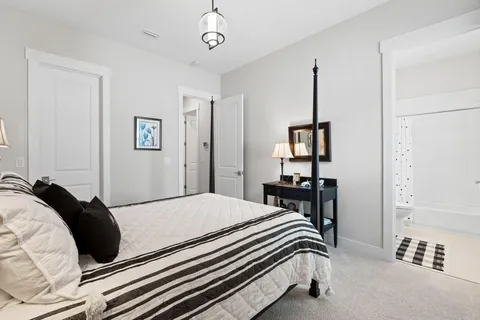 a bedroom with a bed and a table