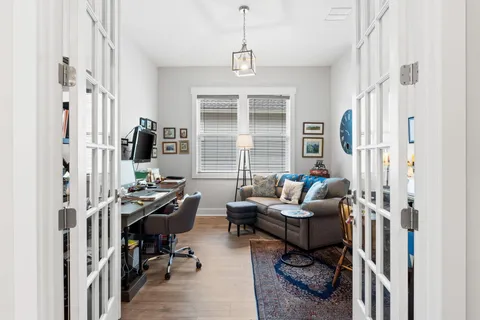 a living room with furniture a window and a wooden floor