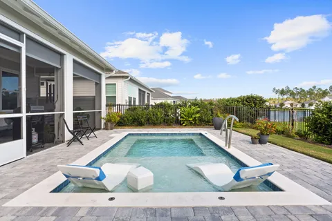 a view of a swimming pool with seating space