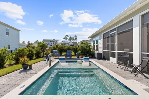 a view of a house with backyard sitting area and garden