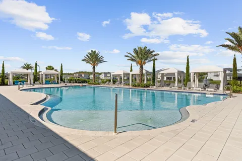 a view of a swimming pool with outdoor seating