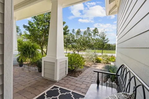 a view of a patio with table and chairs and potted plants