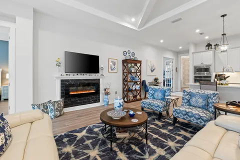 a living room with furniture a flat screen tv and a fireplace
