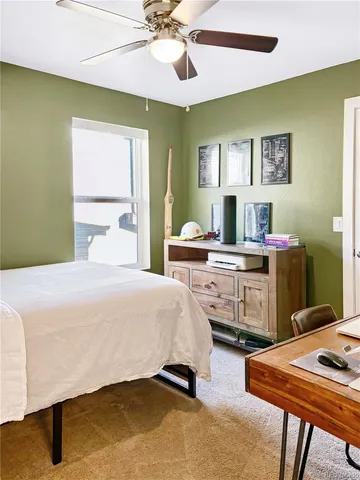 a bedroom with a bed and a desk