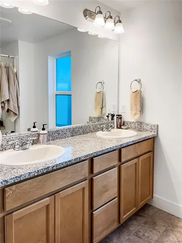 a bathroom with a double vanity sink and a mirror