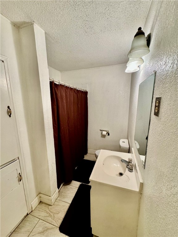 3130 Lasker Avenue Waco, TX 76707 - Photo 13 of 16 a bathroom with a sink a toilet and shower