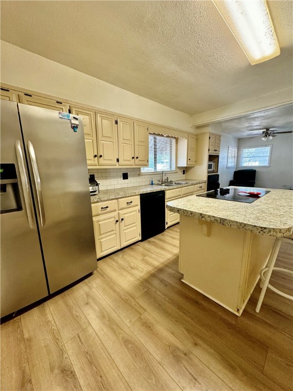 3130 Lasker Avenue Waco, TX 76707 - Photo 7 of 16 a kitchen with stainless steel appliances a refrigerator sink and cabinets