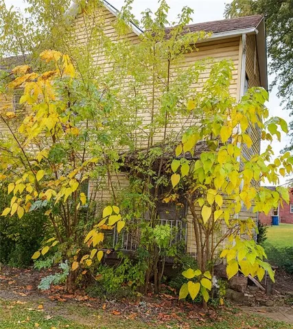 a backyard of a house with large trees