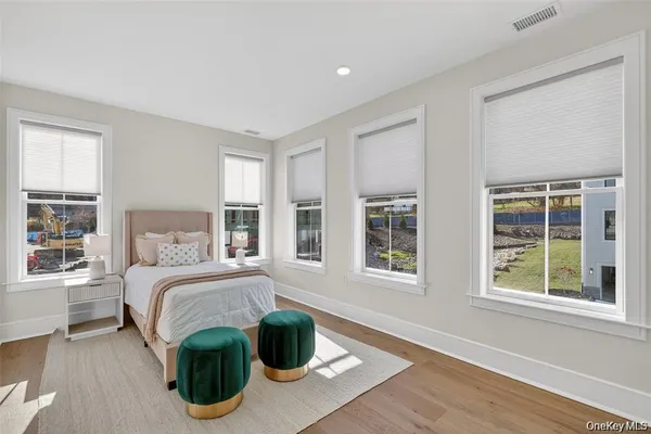 a spacious bedroom with a bed and window