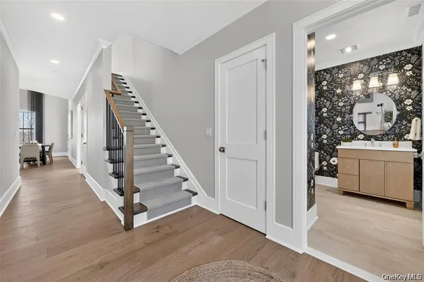 a view of a living room and entryway with wooden floor