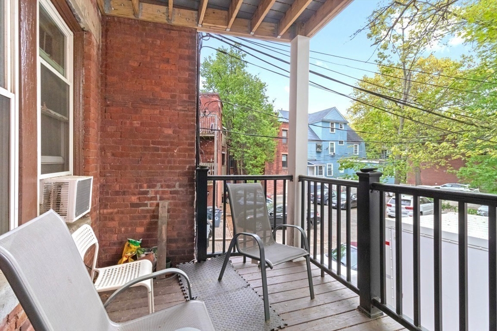8 Colliston Road Boston, MA 02135 - Photo 22 of 40 a view of balcony with wooden floor and outdoor seating
