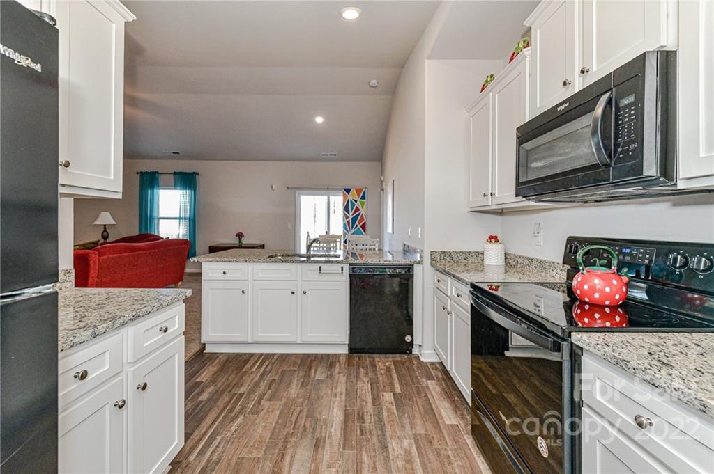 6727 Jerimoth Charlotte, NC 28215 - Photo 11 of 30 a kitchen with stainless steel appliances granite countertop a stove microwave and sink
