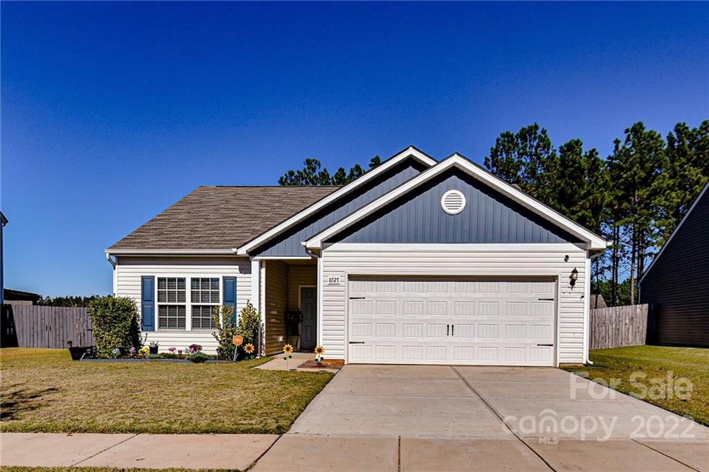 6727 Jerimoth Charlotte, NC 28215 - Photo 3 of 30 a front view of a house with a yard and garage