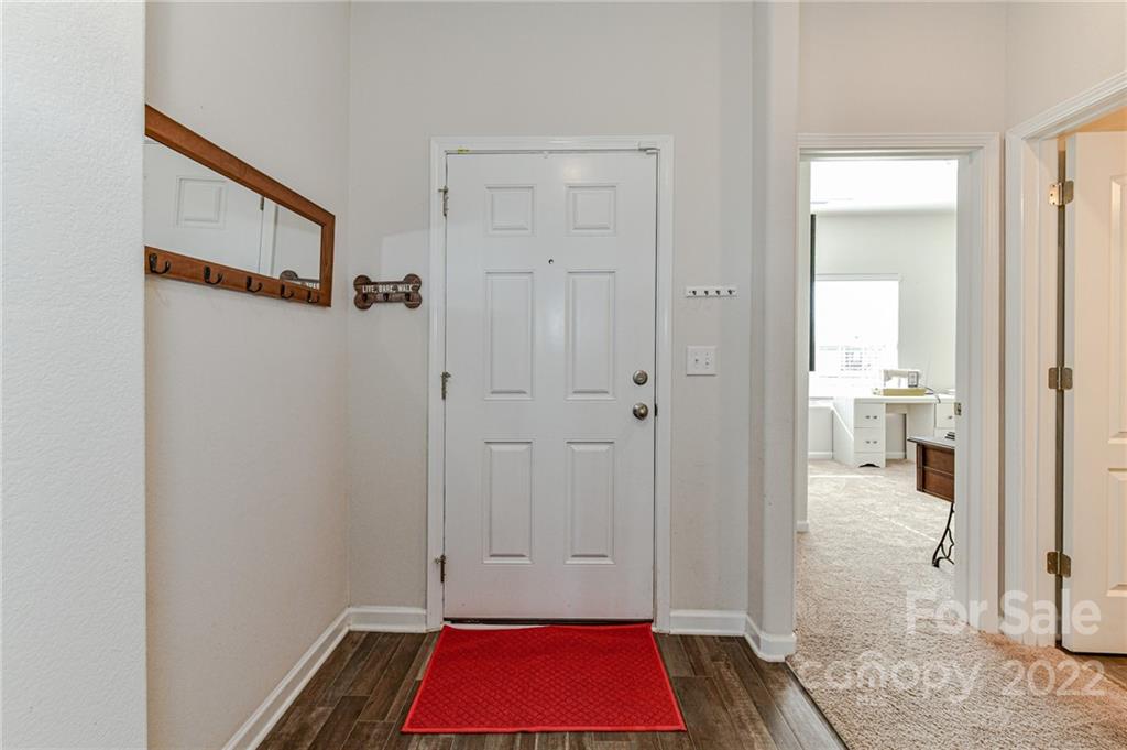 6727 Jerimoth Charlotte, NC 28215 - Photo 5 of 30 a view of a hallway with wooden floor and a bathroom