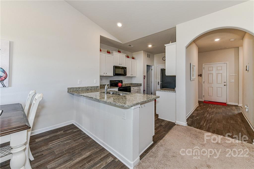 6727 Jerimoth Charlotte, NC 28215 - Photo 9 of 30 a kitchen with stainless steel appliances granite countertop a sink and a refrigerator