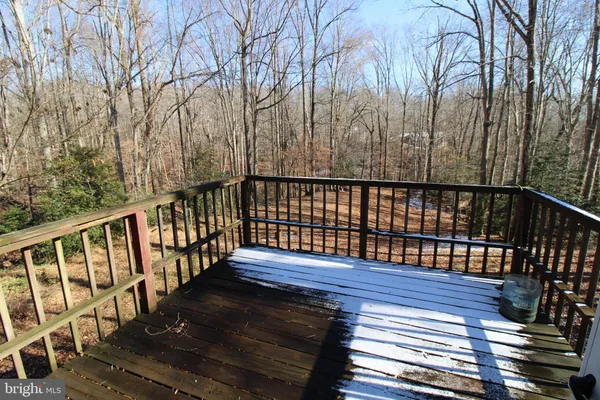 a view of balcony with wooden floor and fence