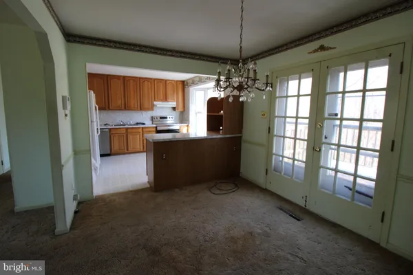 a view of a kitchen and a refrigerator