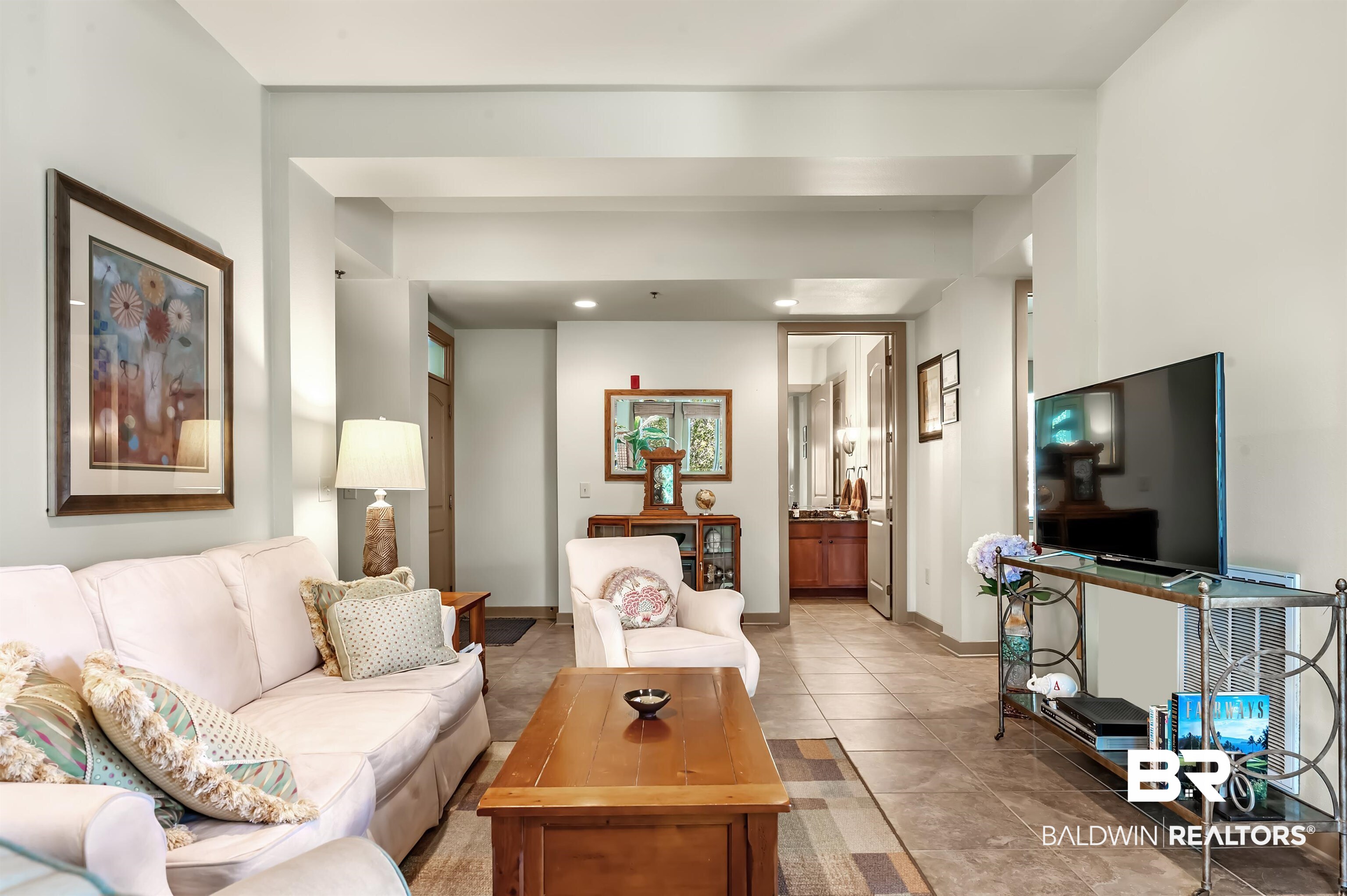 1430 Regency Road, Unit A301 Gulf Shores, AL 36542 - Photo 9 of 47 Living room with light tile patterned floors