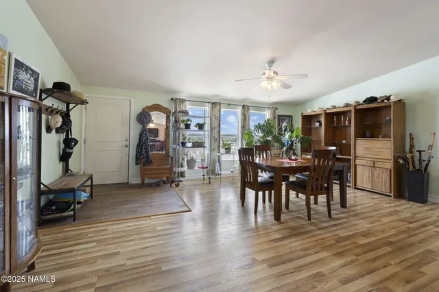 a view of a a dining room with furniture window and wooden floor