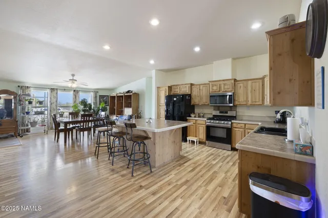 a kitchen with a table chairs microwave and cabinets