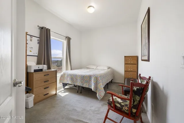 a spacious bedroom with a bed and a desk