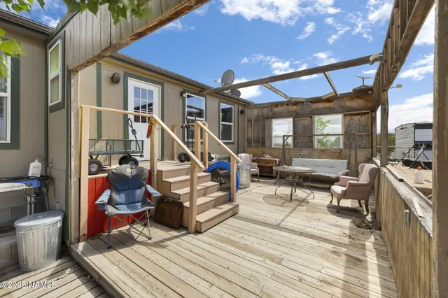 a view of a patio with dining table and chairs with plants