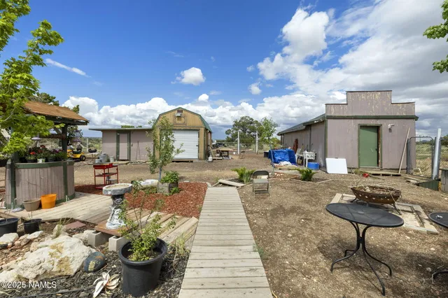 a front view of a house with a large tree