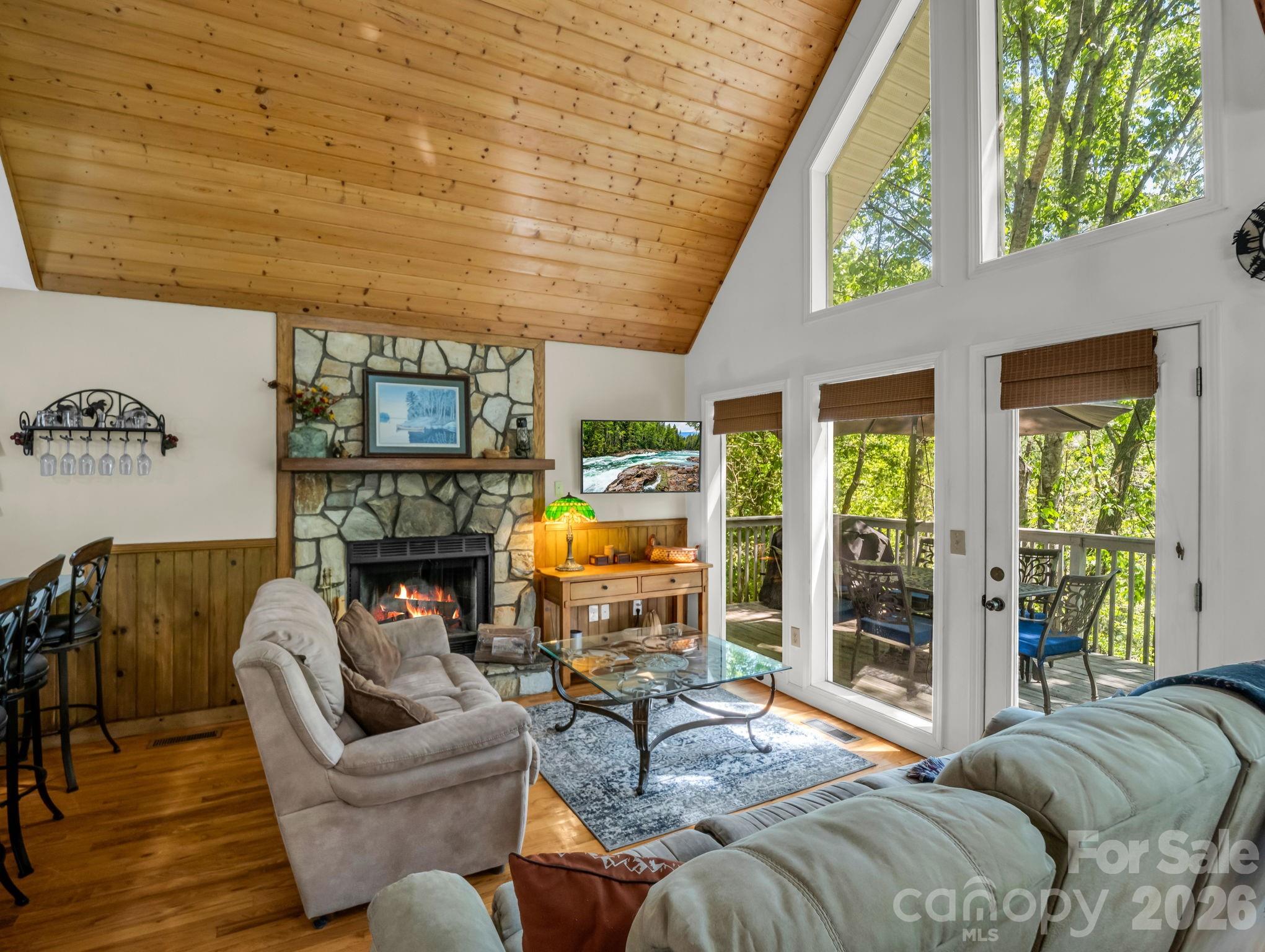 268 Mallard Road Lake Lure, NC 28746 - Photo 15 of 44 a living room with furniture a fireplace and a floor to ceiling window
