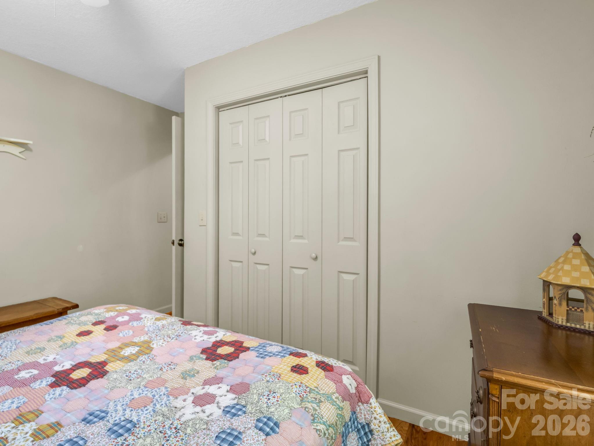 268 Mallard Road Lake Lure, NC 28746 - Photo 21 of 44 a bedroom with a bed and wooden floor