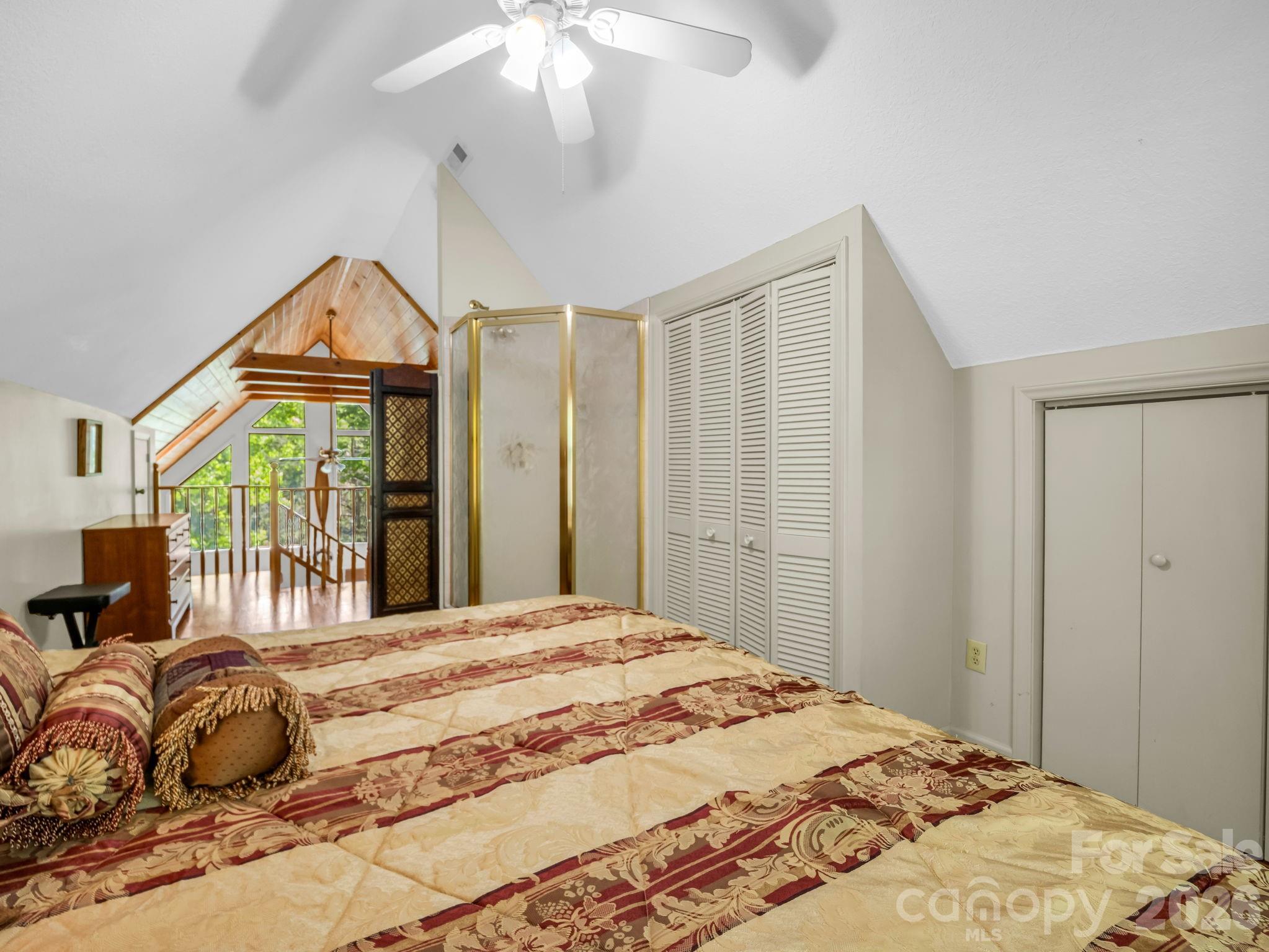 268 Mallard Road Lake Lure, NC 28746 - Photo 26 of 44 a bedroom with a bed and a chandelier