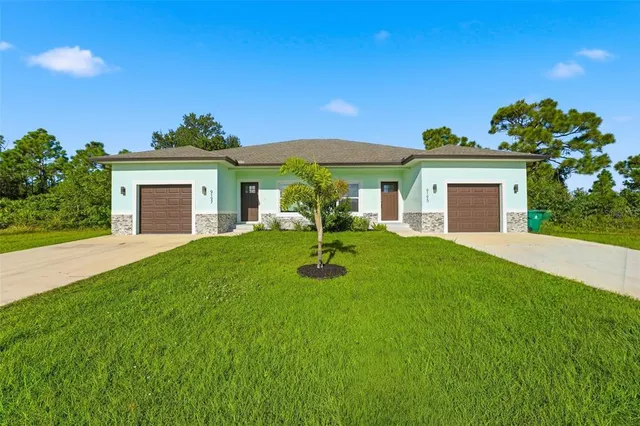 a front view of a house with a garden