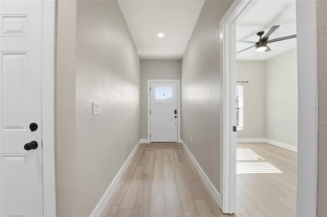 a view of a hallway with wooden floor and closet area