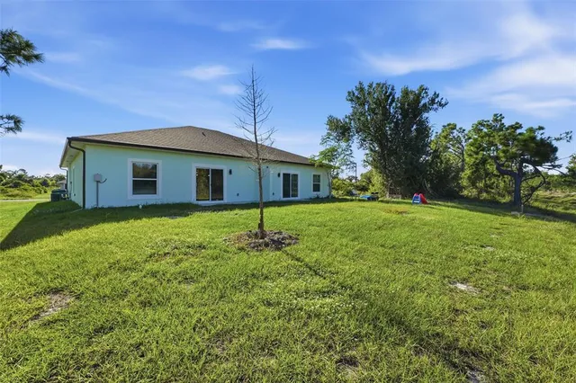 a yellow house with a yard