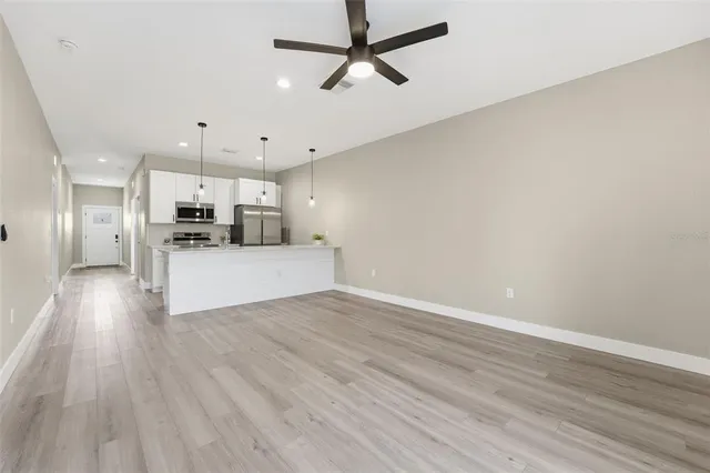 a view of a kitchen with a sink and wooden floor