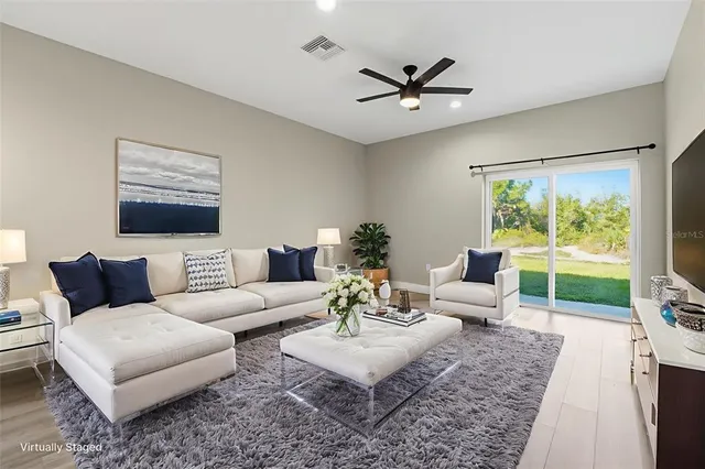a living room with furniture and a large window