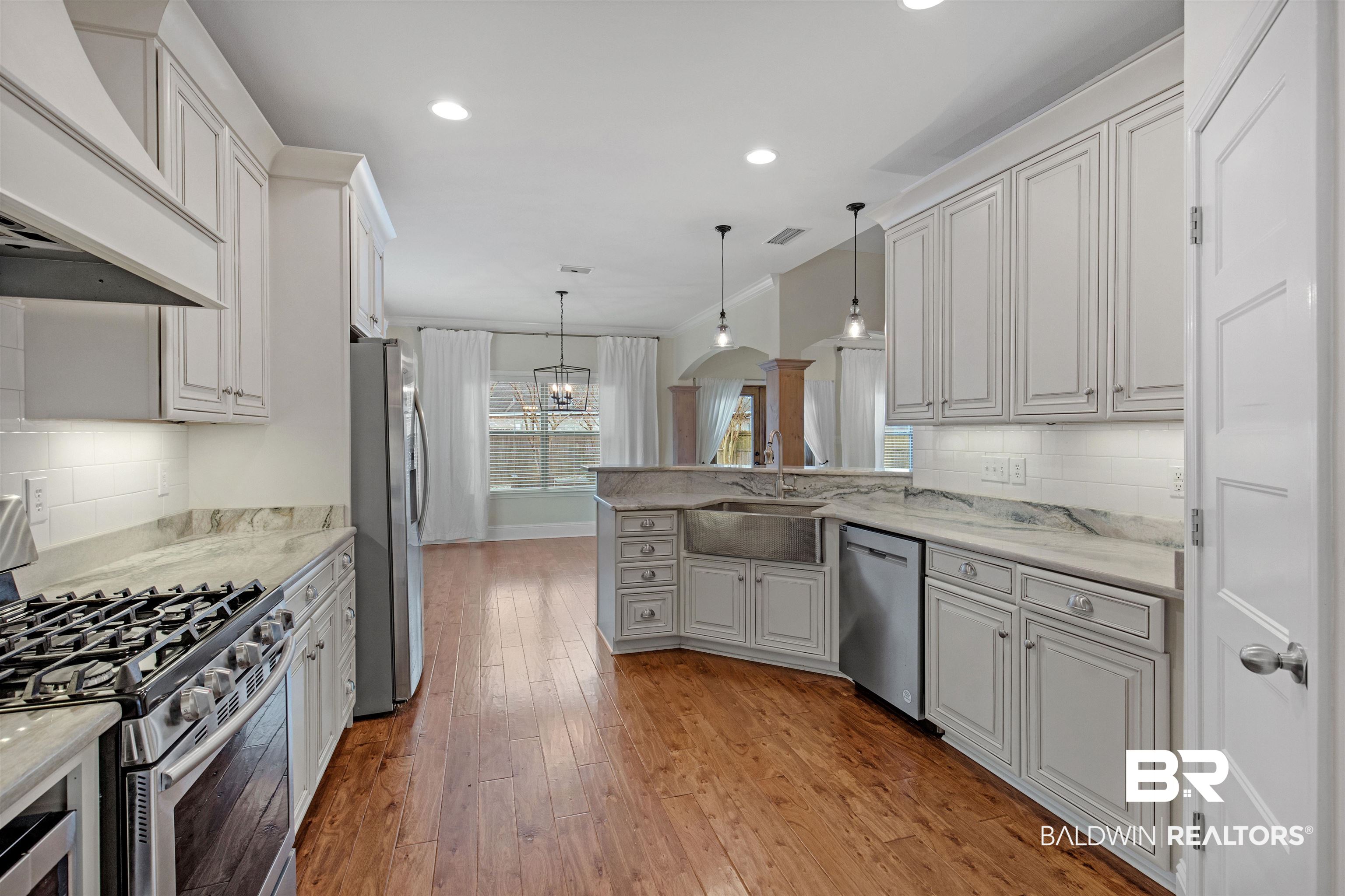 25092 Fairfax Road Daphne, AL 36526 - Photo 13 of 29 Kitchen featuring pendant lighting, sink, custom exhaust hood, and stainless steel appliances