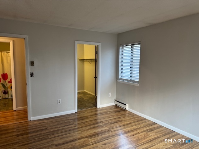 74 Buddington Road, Unit 7 Groton, CT 06340 - Photo 12 of 19 a view of empty room with wooden floor and fan