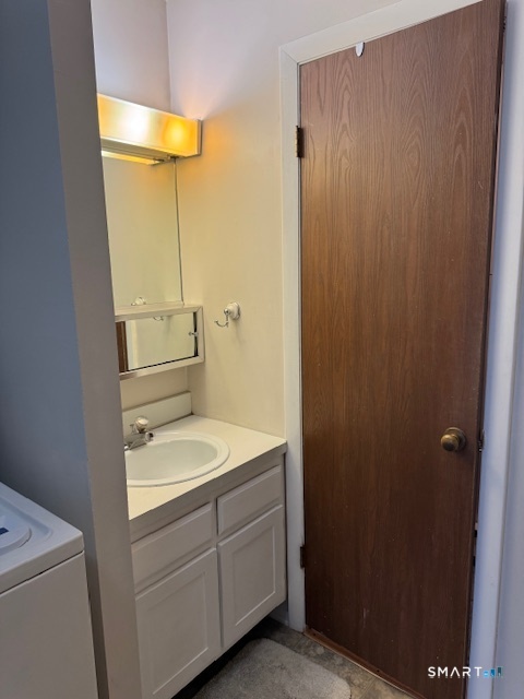 74 Buddington Road, Unit 7 Groton, CT 06340 - Photo 14 of 19 a bathroom with a granite countertop sink toilet and shower